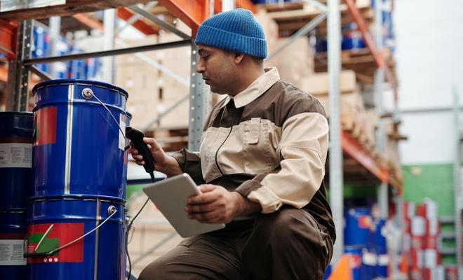 Man scanning a bucket in field environment